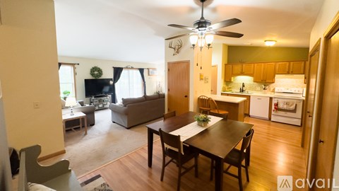 A living room with a dining table and chairs.