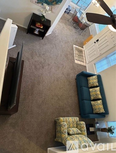 A living room with a blue couch and a television.