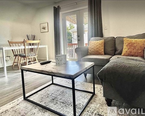 A living room with a grey couch and a coffee table.