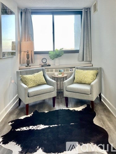 A living room with two chairs and a table.