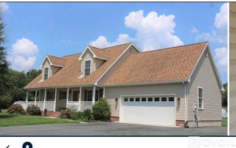 A house with a brown roof and a white garage door.