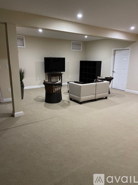 A living room with a television and a cabinet.