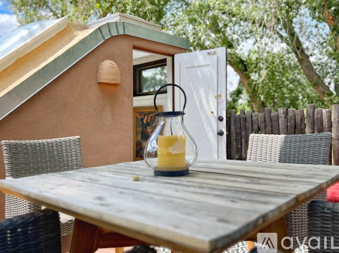 A table with a candle on it in front of a house.