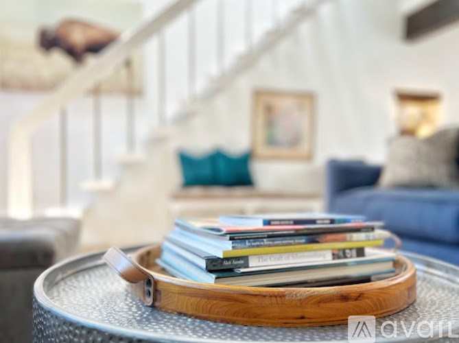 A room with a blue chair and a wooden table.