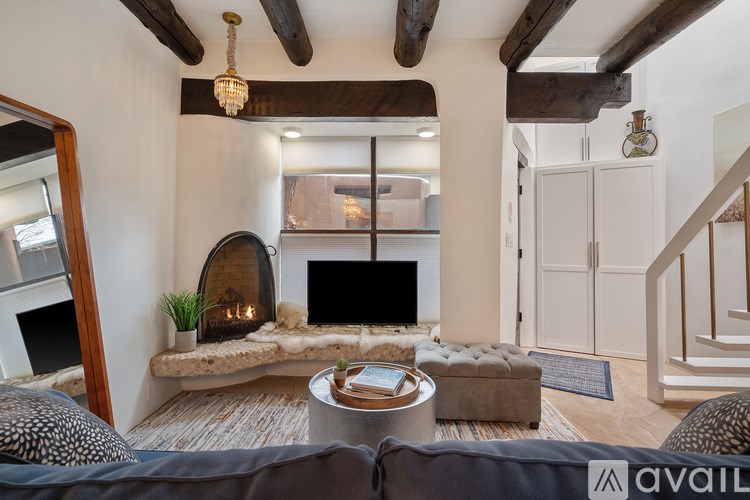 A modern living room with a fireplace and a couch.