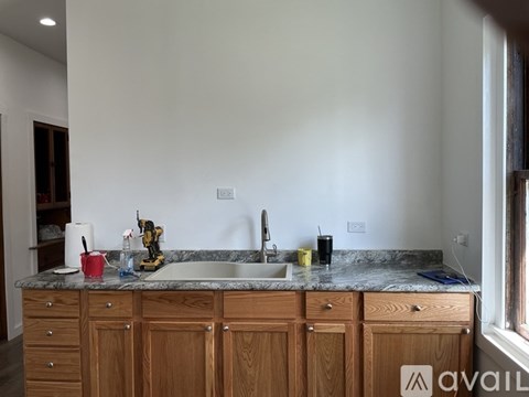 A kitchen with wooden cabinets and a granite countertop.