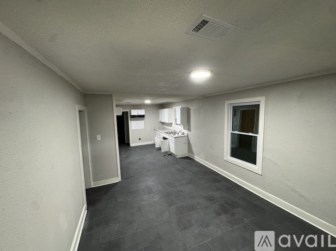 A room with a white ceiling, a white table, and a white fridge.