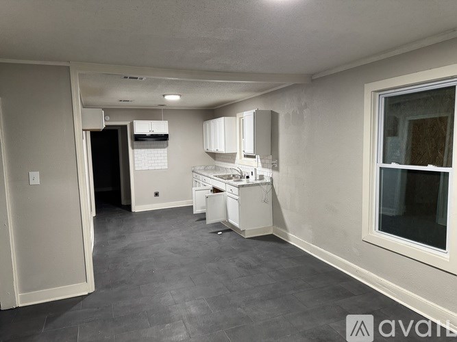 A kitchen area with a refrigerator, microwave, and a dishwasher.