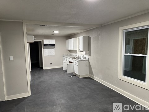 A kitchen area with a refrigerator, microwave, and a dishwasher.
