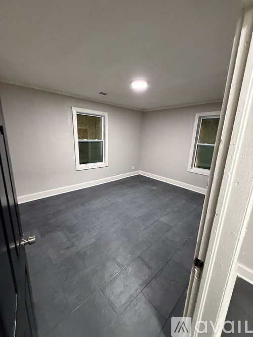 A room with a grey floor and a window.