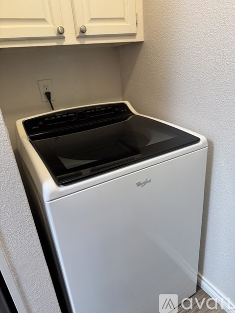 A white Whirlpool dishwasher is sitting in a kitchen.