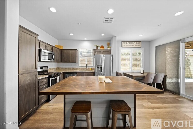 A modern kitchen with a wooden table and chairs.