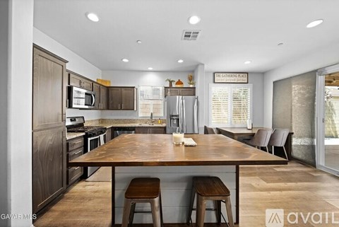 A modern kitchen with a wooden table and chairs.