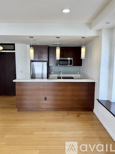 A modern kitchen with wooden cabinets and a central island.