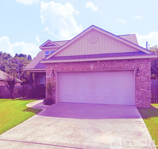 A house with a garage door and a driveway.