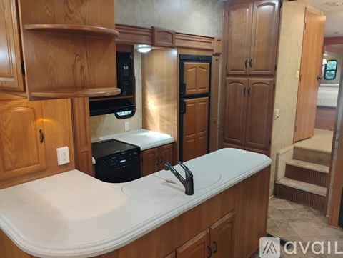 A kitchen with wooden cabinets and a white countertop.