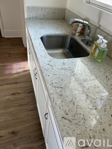 A kitchen counter with a sink and a window.