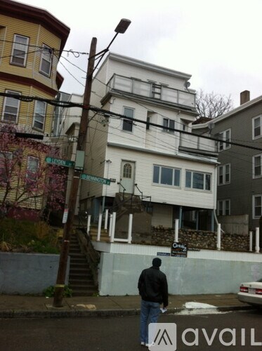 A man is walking on the street with a skateboard in his hand.