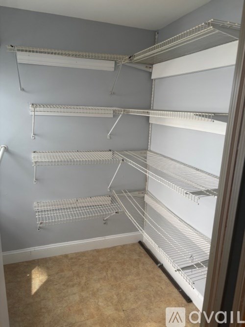 A toilet is in a bathroom with a blue towel on the floor.