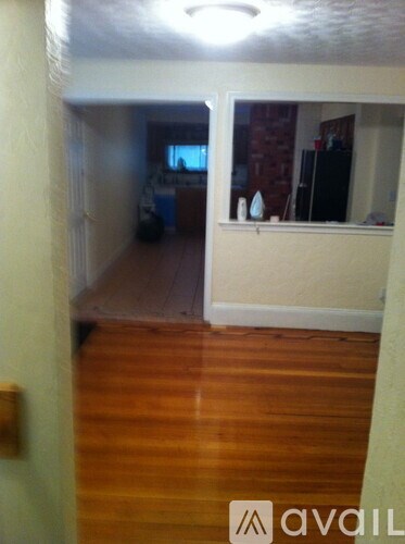 A room with wooden floors and a window.