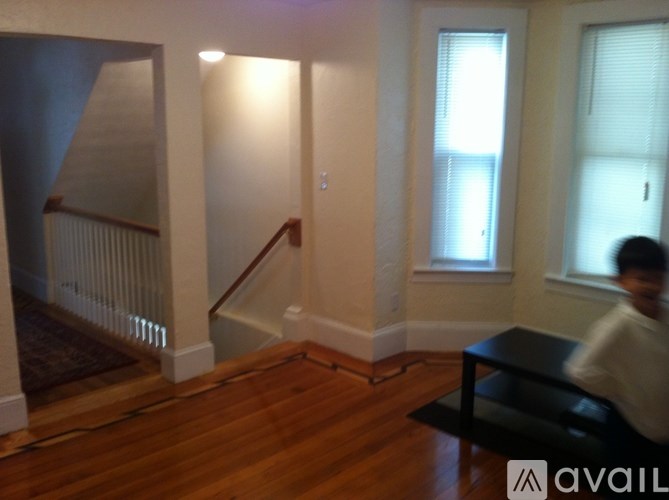 A man is walking down a staircase in a house.