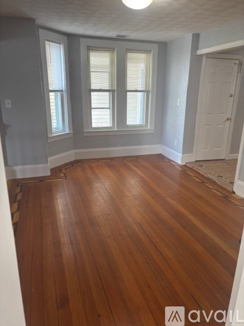 A black table with a red cup on it in a room with a tv.