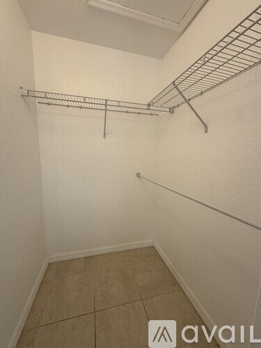 A white wall with a metal rack on it.