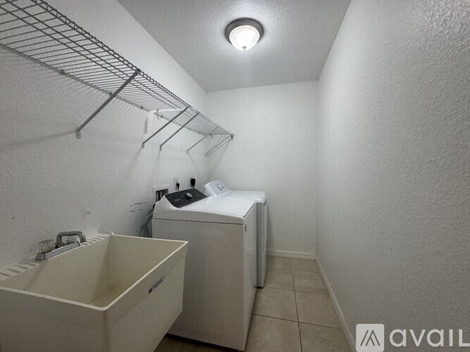 A small laundry room with a washer and dryer.