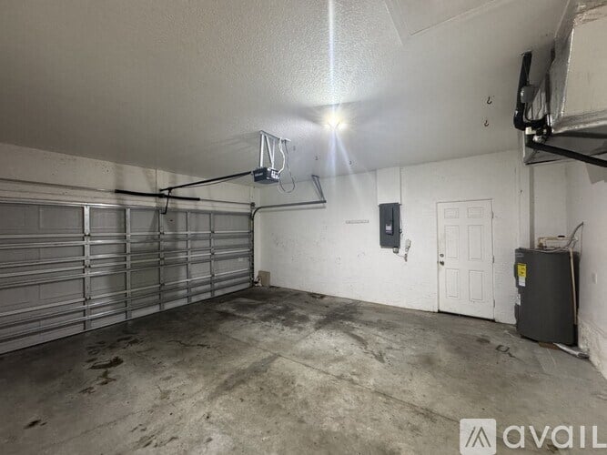 A garage with a basketball hoop and a white door.