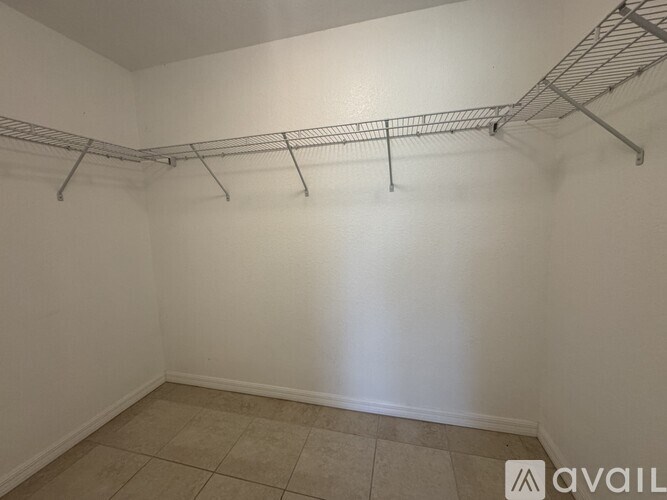 Empty room with white walls and a metal rack on the wall.