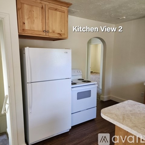 A kitchen with a white refrigerator and stove.