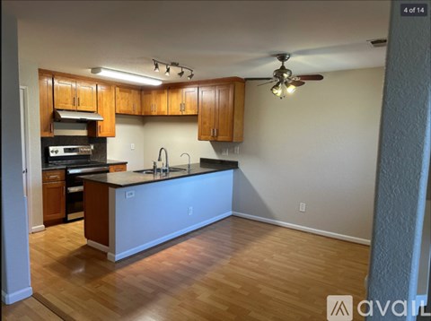 A kitchen with wooden cabinets and a white countertop.