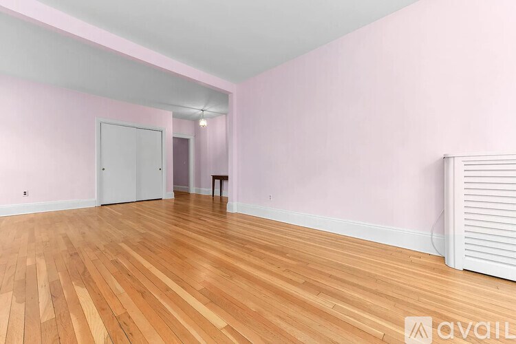 A room with wooden floors and a white radiator.