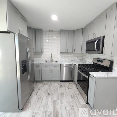 A kitchen with a refrigerator, stove, and oven.