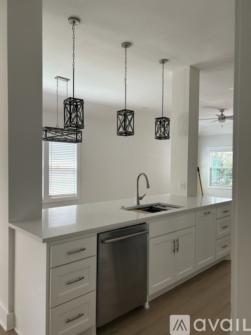 A kitchen with a dishwasher and cabinets.