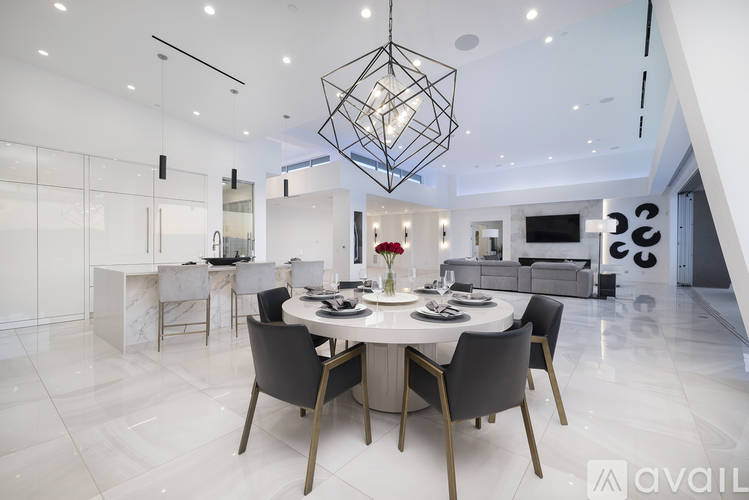 A modern dining room with a large table and chairs.