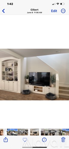 A modern living room with a television and a staircase.
