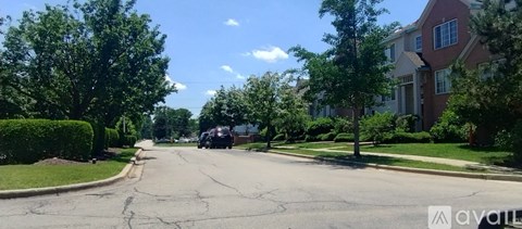 A street view of a residential area with houses on both sides.