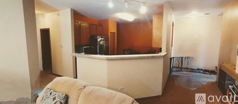 A living room with a white couch and a bar area.