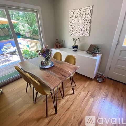 A dining room with a wooden table and chairs.