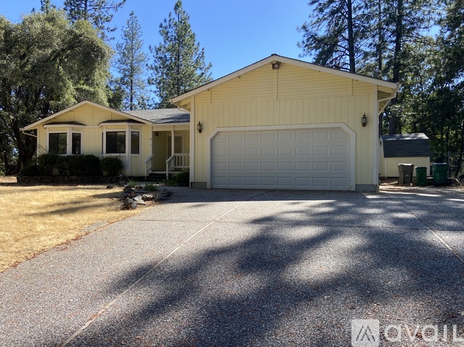 A two-story house with a garage and a driveway.