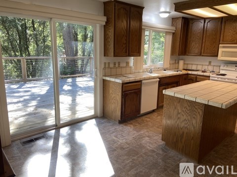 A kitchen with wooden cabinets and a large island.
