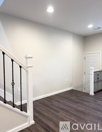 A room with a staircase and a door.