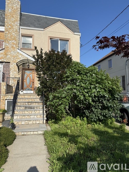 A house with a stone pillar and a wooden door.