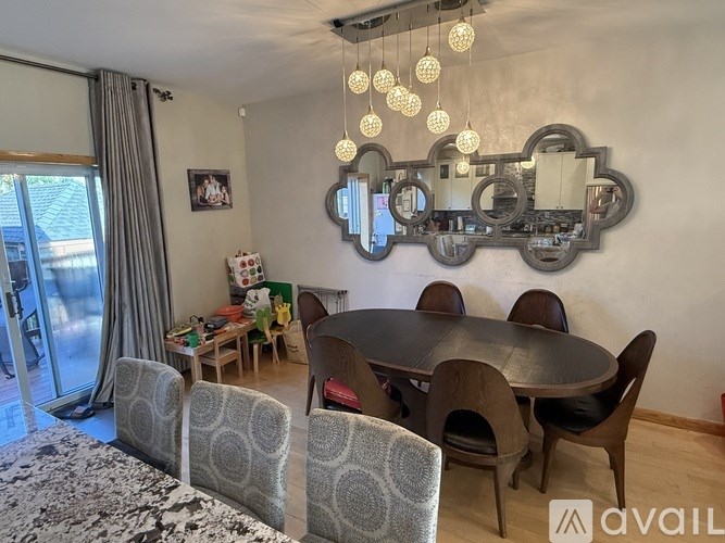 A dining room with a round table and chairs.