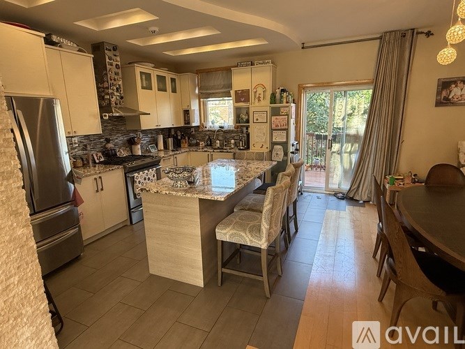 A kitchen with a table and chairs in front of a window.