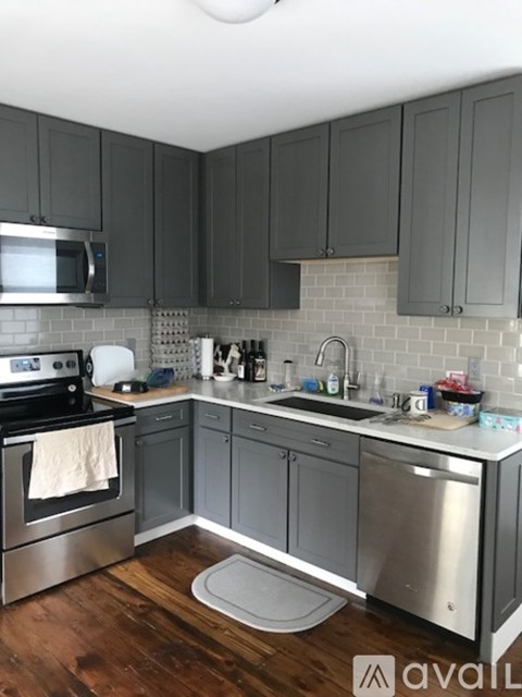 A kitchen with a stove top oven and a microwave.