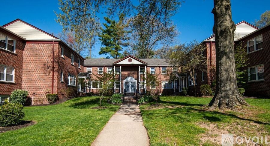 A sunny day at a brick apartment complex with a clear blue sky.