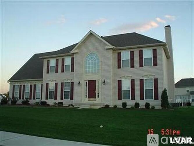A house with red and white shutters is shown.
