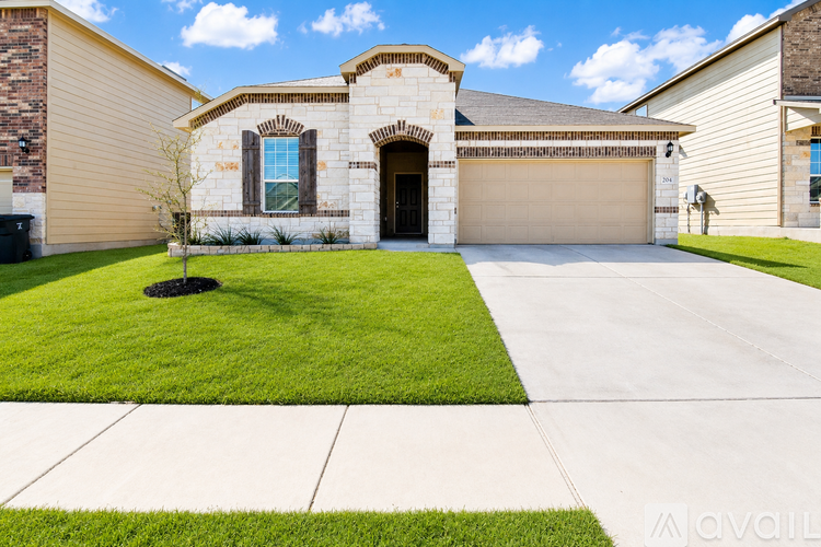 A house with a garage and driveway in front.